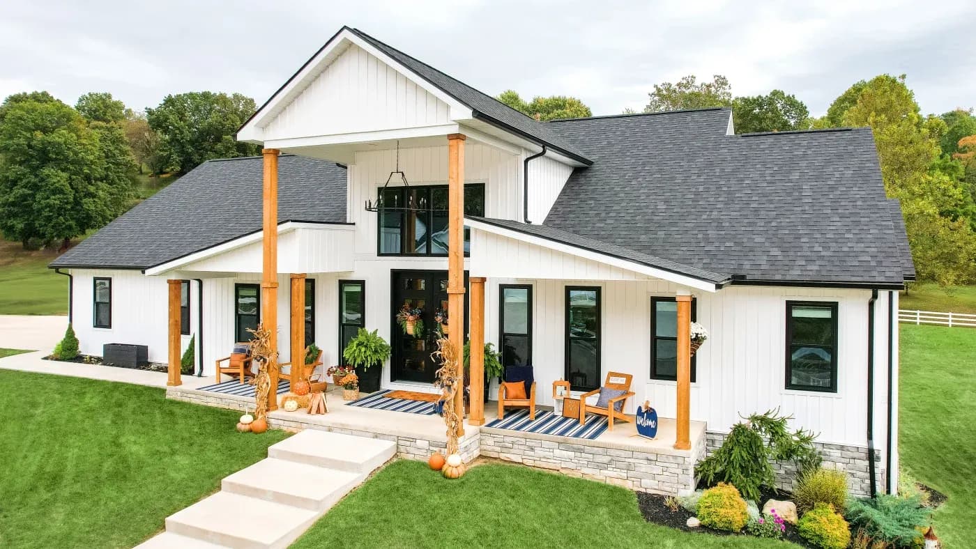 Large white house with green lawn.